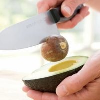 Step 2. Tap the exposed pit with the heel of a chef's knife. It will pull out from the avocado. Carefully push the pit off the blade of the knife.